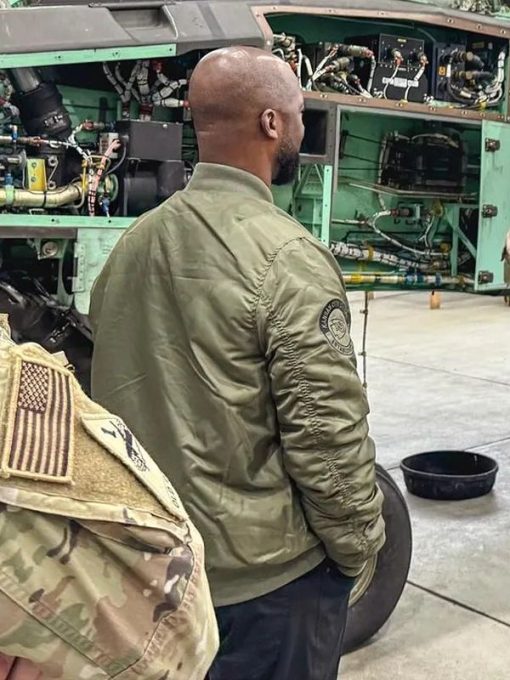 Kansas-City-Chiefs-EST.1960-Dante-Hall-Military-2024Bomber-Jacket-510x680-1 Person wearing a green jacket with a patch in front of an aircraft engine in USA