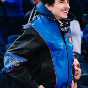 Person wearing a blue and black jacket with visible branding in an indoor setting